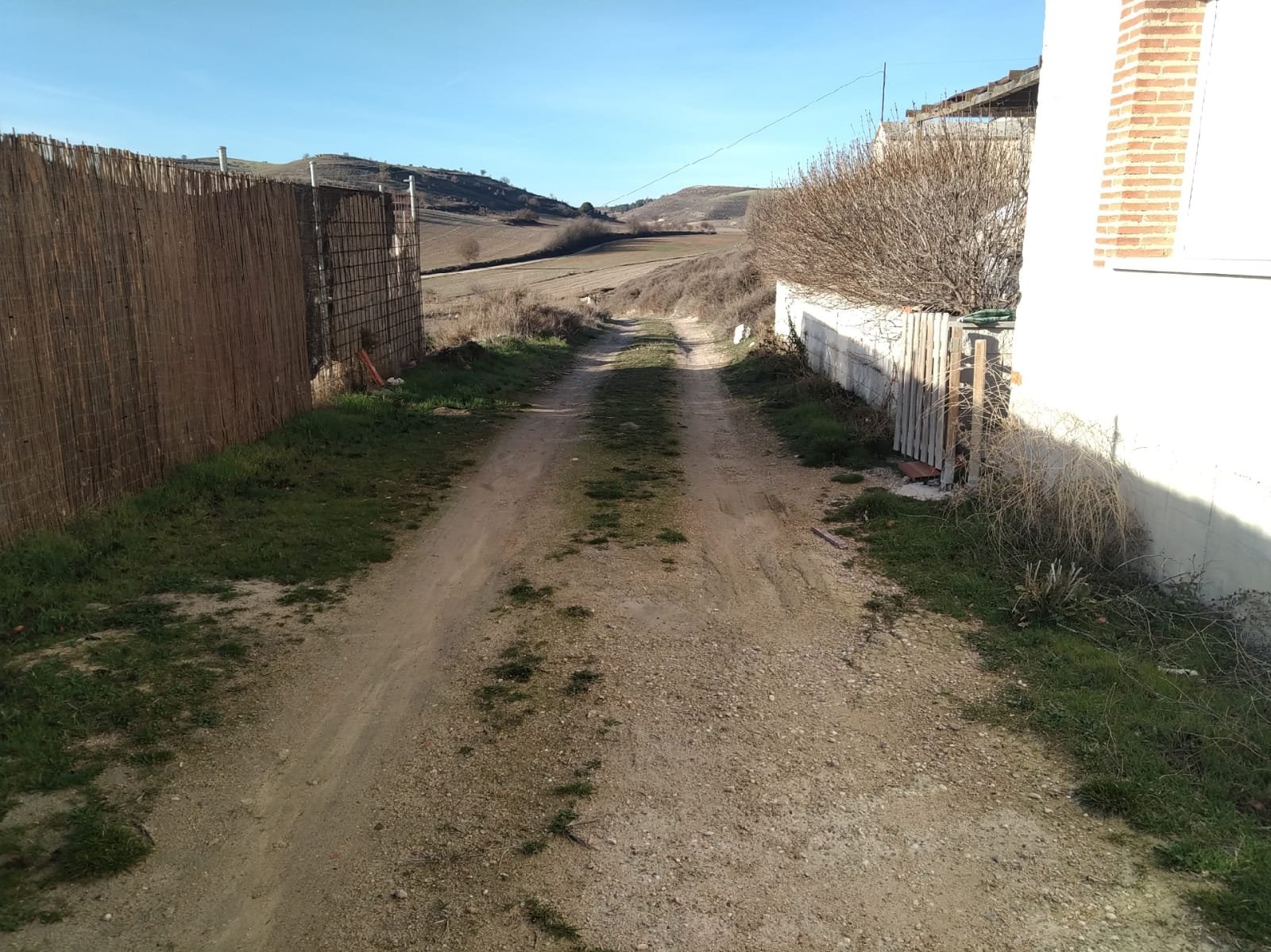 Maquinaria de excavación nivelando las calles en casco urbano de Molpeceres